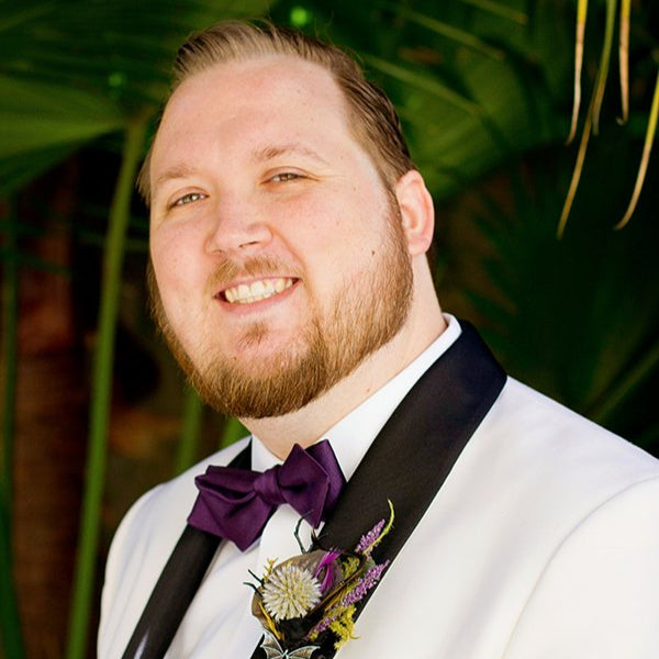 image of the artist in a white tux